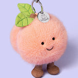 Jellycat - Breloque Pêche Amuseables Peach Bag Charm - APEACH4BC - Debout Sur Fond Lavande